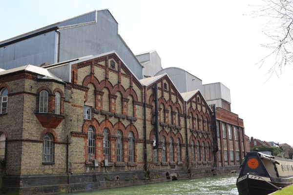 Landscape photo of the old Osney Power Station alongside a canal