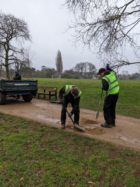 Parks staff filling in potholes