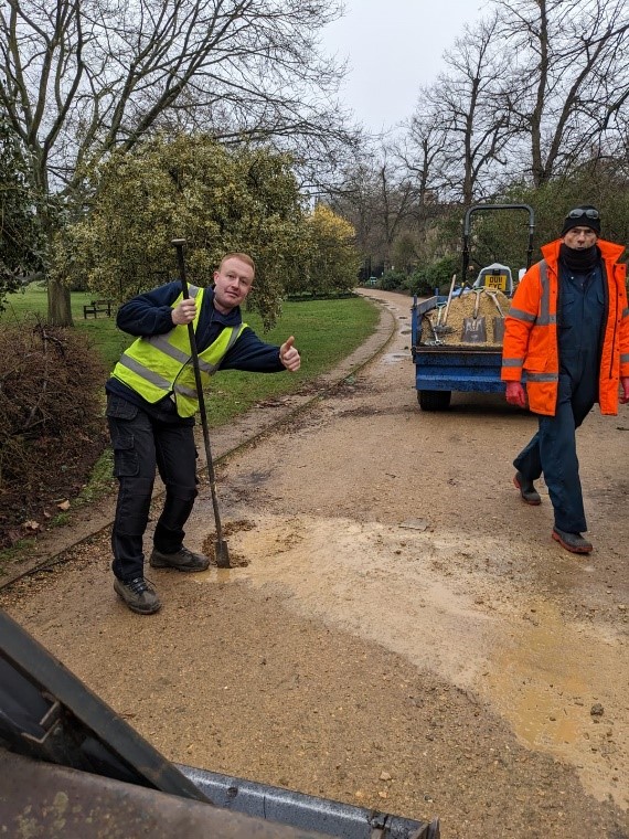 Parks staff filling in potholes